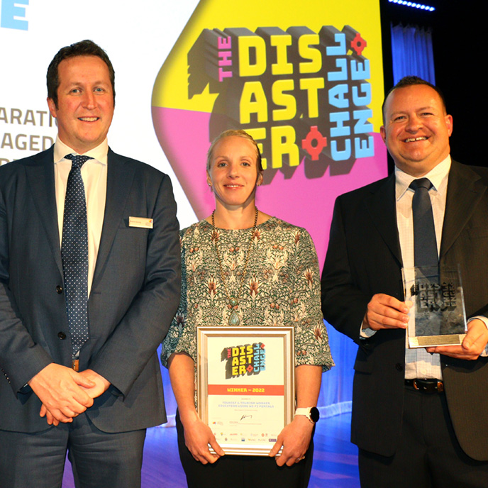 CEO Andrew Gissing with the 2022 Disaster Challenge winners Kamarah Pooley and Mark Owens