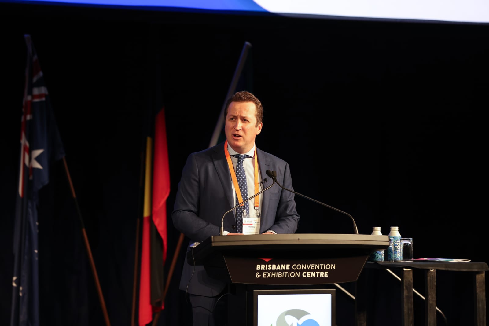A photo of Andrew Gissing on stage at AFAC23. 