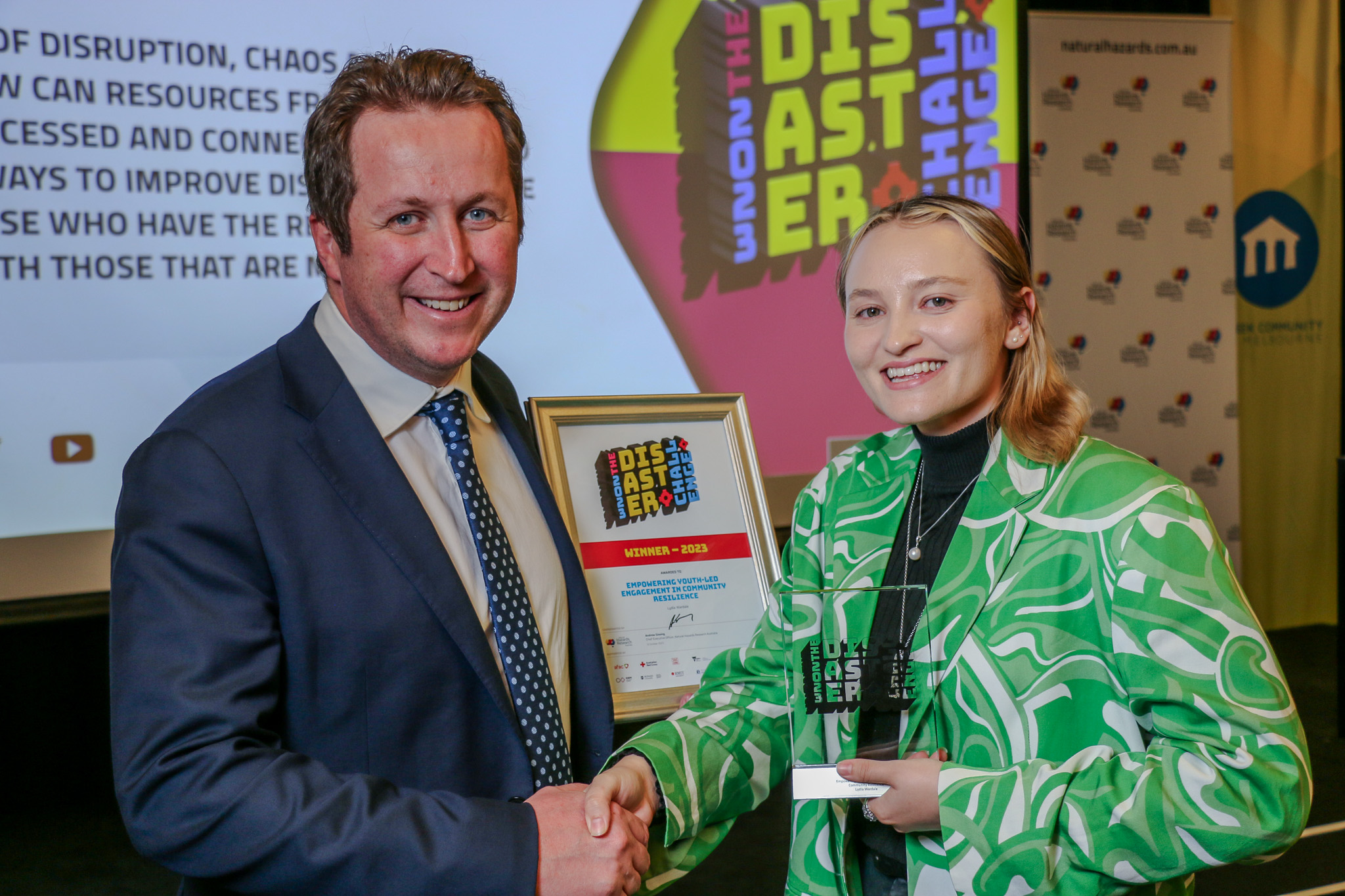 Lydia Wardale accepts the Disaster Challenge winner's trophy from Andrew Gissing.
