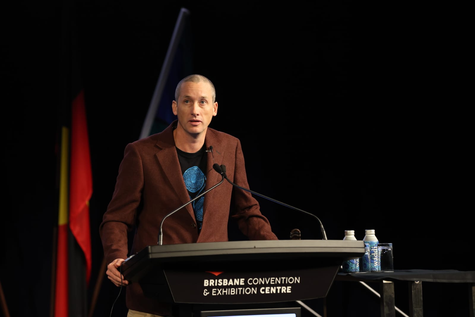 A photo of Oliver Costello giving a keynote at AFAC23. 