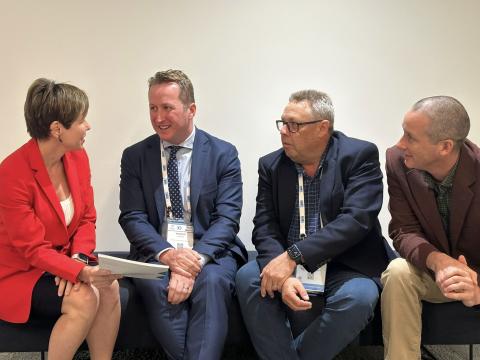 Four people sitting down talking